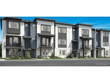 Modern townhome exterior showcasing gray and white color schemes, with balconies and well-maintained landscaping at 688 Belay St, Erie, CO 80516