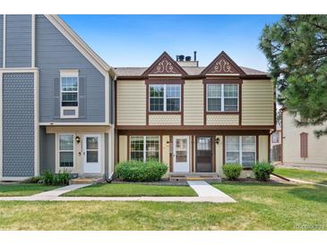 Charming two-story townhome with manicured lawn and inviting entrance at 14485 E Hawaii Cir # B, Aurora, CO 80012