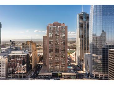 Stunning high-rise exterior view with city skyline and mountain backdrop at 1020 15Th St # 15K, Denver, CO 80202