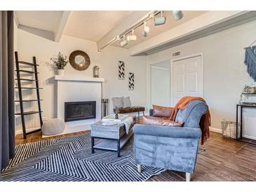 Cozy living room featuring a fireplace, comfortable seating, and stylish decor at 9995 E Harvard Ave # 224, Denver, CO 80231