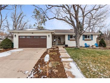 Ranch style home with brown garage door, white brick exterior, and landscaping at 551 E Caley Dr, Centennial, CO 80121