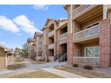 Inviting multi-story condo building featuring balconies, brick accents, and well-maintained landscaping at 1632 W Canal Cir # 924, Littleton, CO 80120