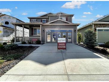 Two-story Craftsman home with gray siding, light-colored stone accents, and a three-car garage at 4525 Cholla Trl, Castle Rock, CO 80104