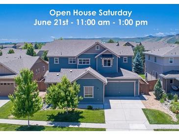 Inviting two-story home featuring manicured lawn and an open house invitation displayed across the top at 15378 W 50Th Pl, Golden, CO 80403
