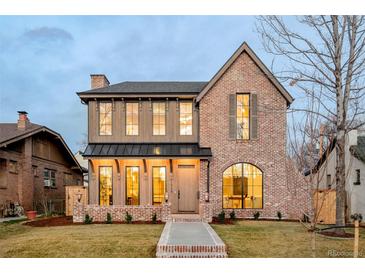 Charming two-story brick home showcasing elegant architectural details, a welcoming front porch, and well-maintained landscaping at 1968 S Washington St, Denver, CO 80210