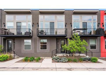 Modern townhomes with black iron railings and gray exterior paint, plus a small balcony at 3480 E 31St Ave, Denver, CO 80205