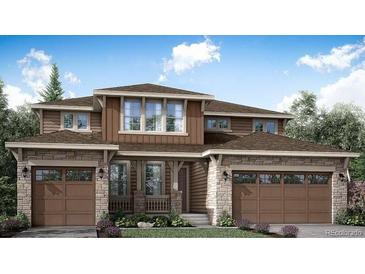 Charming two-story home with a symmetrical design, stone accents, and a welcoming front porch at 3979 Descent St, Castle Rock, CO 80108