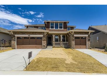 Two-story home features a 3-car garage, stone accents, covered porch and freshly landscaped front yard at 3979 Descent St, Castle Rock, CO 80108