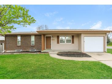 Charming single-story home featuring a brick facade and attached garage at 405 Cypress St, Broomfield, CO 80020