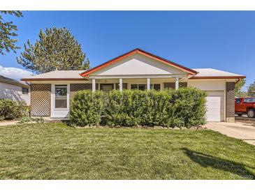 Charming single-story home with well-maintained lawn and mature front yard landscaping at 11816 Spring Dr, Northglenn, CO 80233