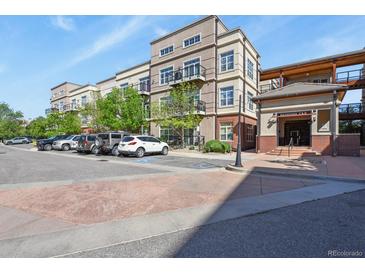 Attractive condo building featuring balconies, well-maintained landscaping, and convenient parking in a desirable location at 5677 S Park Pl # 303, Englewood, CO 80111