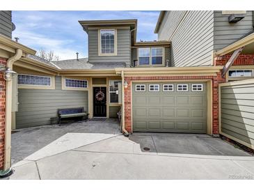 Inviting home exterior with brick accents and a welcoming front door adorned with a wreath at 12831 King St, Broomfield, CO 80020