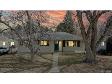 Charming one-story home with mature trees and a cozy front porch perfect for relaxing at 1852 S Forest St, Denver, CO 80222