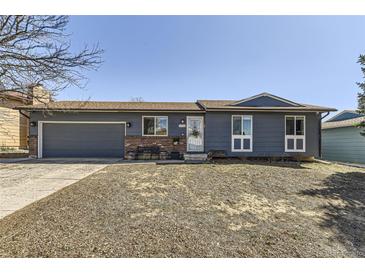 Charming single-story home with a well-maintained front yard, a newer garage door, and a welcoming entrance at 1756 S Memphis St, Aurora, CO 80017