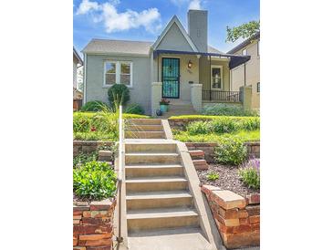 Charming bungalow featuring a beautifully landscaped front yard and inviting front entrance at 1208 S Elizabeth St, Denver, CO 80210