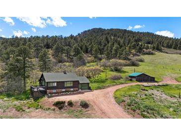 Charming home with a forest backdrop, barn, and large parcel at 15947 S Perry Park Rd, Palmer Lake, CO 80133