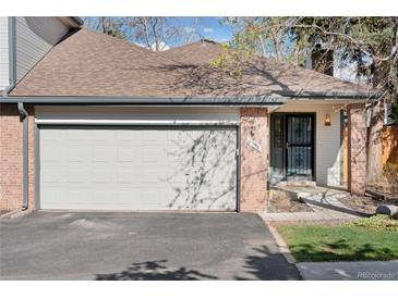 Charming exterior featuring a brick facade, attached garage, and well-maintained landscaping at 6358 S Jackson St, Centennial, CO 80121