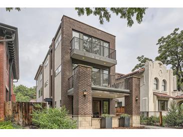 Contemporary three-story brick home featuring dual balconies and modern architectural design at 1895 York St, Denver, CO 80206