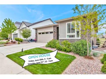 Charming single-Gathering home with a manicured lawn and an attached two-car garage and visible open house banner at 9055 Swan River St, Littleton, CO 80125