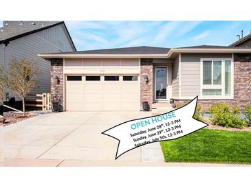 Charming single-Gathering home with a two-car garage, stone accents, and well-maintained landscaping on a sunny day at 9055 Swan River St, Littleton, CO 80125