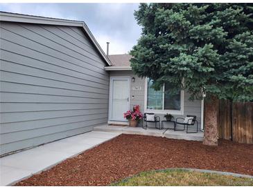 Charming home entrance with seating area and well-maintained landscaping at 17411 E Layton Dr, Aurora, CO 80015