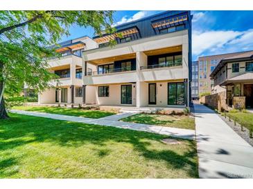 Modern townhome with balconies, well-kept lawn, and stylish architectural details at 1937 S Columbine St, Denver, CO 80210