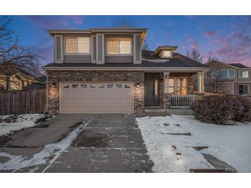 Two-story brick home with attached garage and landscaping at 20572 E Girard Dr, Aurora, CO 80013