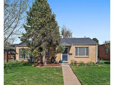 Charming single story home boasts a lush front lawn, mature tree, and welcoming walkway to the front door at 4530 S Pennsylvania St, Englewood, CO 80113