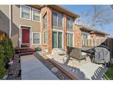 Charming exterior view with a brick facade, outdoor seating, and a well-manicured walkway to the front door at 5926 S Jellison St # B, Littleton, CO 80123