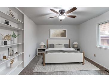 This bedroom boasts a ceiling fan, natural light and nice built-ins on the left side of the shot at 53 S Eagle Cir, Aurora, CO 80012