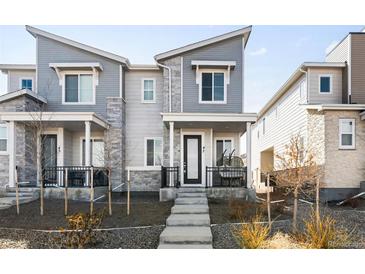 Stylish two-story townhome featuring stone accents and a covered front porch with space to relax at 47 N Uriah St, Aurora, CO 80018