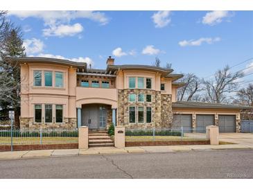 Stunning two-story home with stone accents, a gated yard, and a three-car garage at 115 S Jasmine St, Denver, CO 80224