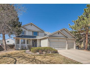 Charming two-story home with a three-car garage and covered front porch at 5251 Altura St, Denver, CO 80239