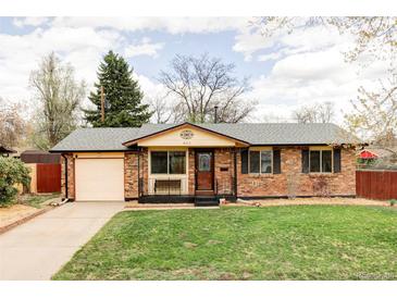 Charming brick home with a well-maintained lawn and a one car garage at 822 S Worchester St, Aurora, CO 80012