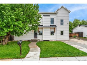 Charming two-story home with a well-maintained lawn and a welcoming walkway to the front door at 13483 Alcott Way, Broomfield, CO 80020