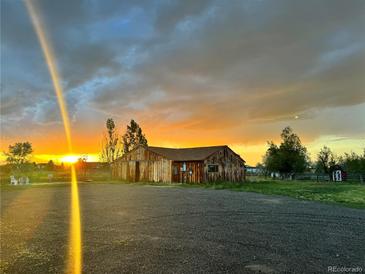 Rustic barn with a golden sunset backdrop and plenty of open space at 5557 Aspen Ave, Erie, CO 80516