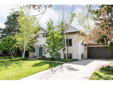 Charming stucco home with mature trees, large driveway, and attached two-car garage at 3445 S Clermont St, Denver, CO 80222