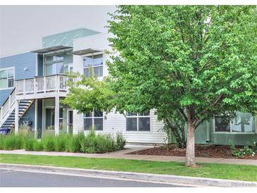 A contemporary two-story exterior featuring wood-grain siding and well-maintained landscaping and healthy trees at 2809 Syracuse Ct # 129, Denver, CO 80238