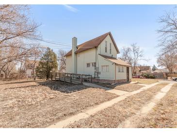 Charming two-story home featuring a ramp, chimney, and inviting facade at 3901 Alcott St, Denver, CO 80211