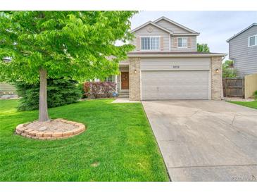 Charming two-story home with a well-manicured lawn and a large tree in the front yard at 5532 S Valdai Way, Aurora, CO 80015