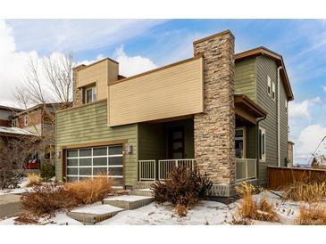 Two-story modern home with stone accents and a large garage at 10081 Truckee St, Commerce City, CO 80022