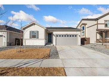 Charming single-story home with a two-car garage and well-manicured lawn at 18953 E 97Th Ave, Commerce City, CO 80022