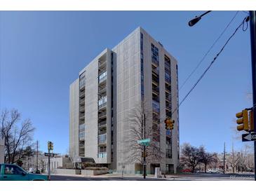 Striking building exterior featuring a modern design with balconies against a bright blue sky backdrop at 777 Washington N St # 802, Denver, CO 80203