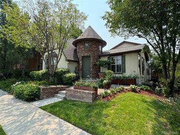 Charming two-story home with lush landscaping and a distinctive turret entrance at 9140 E 29Th Ave, Denver, CO 80238