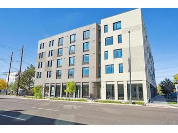 Modern apartment building with a combination of gray and white brick facade, large windows, and street view at 603 Inca St # 330, Denver, CO 80204