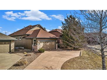 Beautiful exterior view of home featuring a wide driveway and attached two-car garage at 23951 E Easter Pl, Aurora, CO 80016