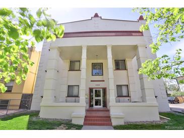 Inviting apartment building entrance, showcasing red brick steps, colonnades, and a well-manicured lawn at 1629 N Clarkson St # 13, Denver, CO 80218