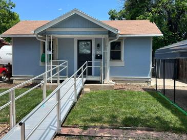 Charming single-story home featuring a ramp, blue siding, and well-maintained lawn at 1738 Dallas St, Aurora, CO 80010