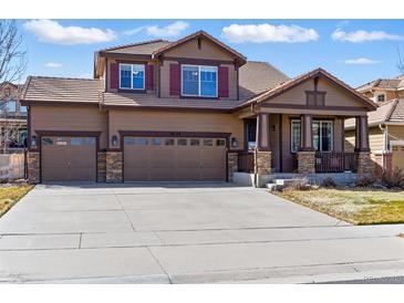 Charming two-story home with a three car garage, covered porch, and well-maintained landscaping at 18130 Bolero Dr, Parker, CO 80134