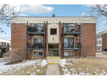 Brick apartment building with balconies and a well-maintained lawn at 5995 W Hampden Ave # 5I, Denver, CO 80227